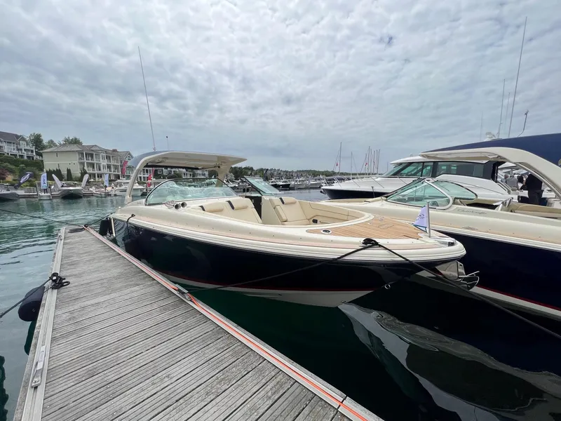 The Image of 2025 Chris-Craft Launch 35 GT docked at a marina under cloudy skies. - 0