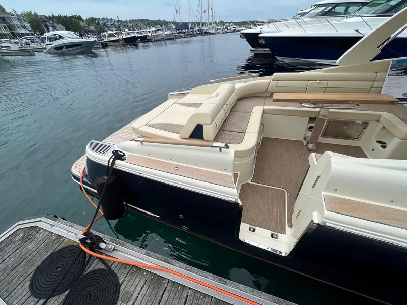 Slide: The Image of 2025 Chris-Craft Launch 35 GT docked, showcasing luxurious seating and sleek design. - 15