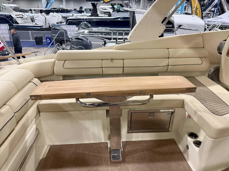 Slide: The Image of 2025 Chris-Craft Launch 35 GT interior with beige seating and wooden table. - 4