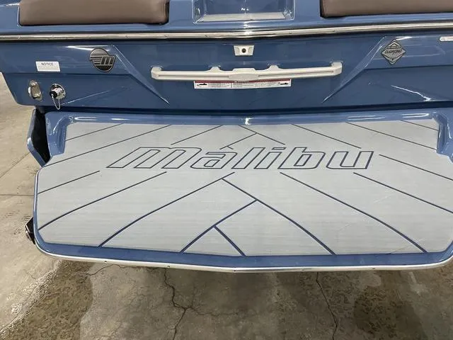 Slide: The Image of 2024 Malibu 23 LSV boat rear view with branded swim platform. - 10