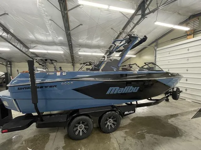 Slide: The Image of 2024 Malibu 23 LSV boat in a garage, featuring sleek design and modern features. - 9