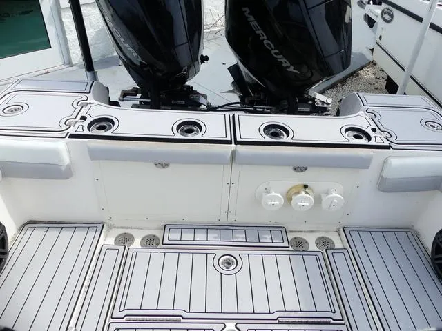 Slide: The Image of 2018 ShearWater 270 Carolina Flare boat deck with dual Mercury engines. - 12