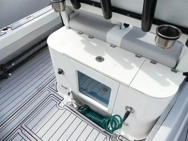 Slide: The Image of 2018 ShearWater 270 Carolina Flare boat interior with storage and rod holders. - 13