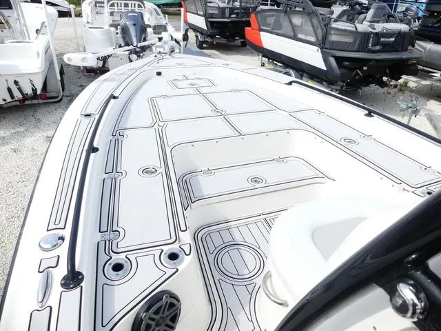 Slide: The Image of 2018 ShearWater 270 Carolina Flare boat deck, sleek design, parked among other boats. - 14