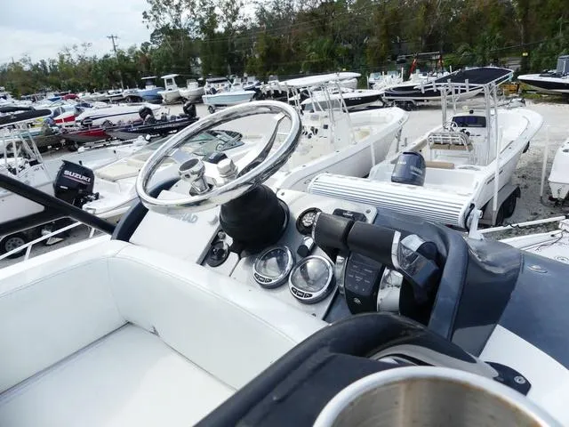 Slide: The Image of 2018 ShearWater 270 Carolina Flare boat dashboard in a marina. - 22