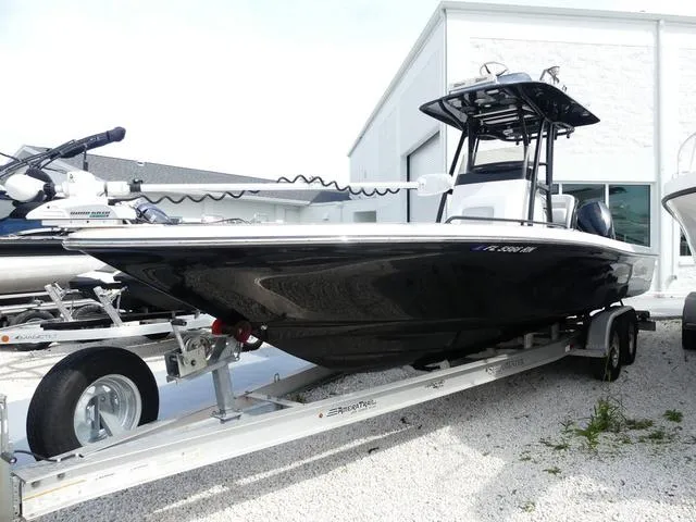 Slide: The Image of 2018 ShearWater 270 Carolina Flare boat on trailer, parked outside a building. - 3