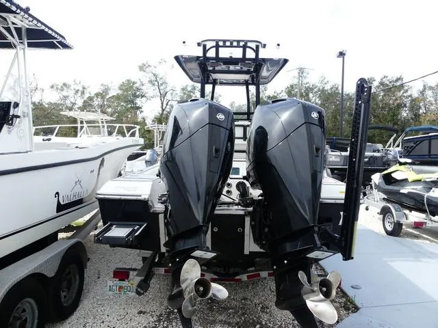 Slide: The Image of 2018 ShearWater 270 Carolina Flare with dual outboard motors, docked in a marina. - 5
