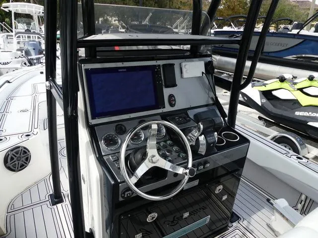 Slide: The Image of 2018 ShearWater 270 Carolina Flare boat console with steering wheel and navigation system. - 9