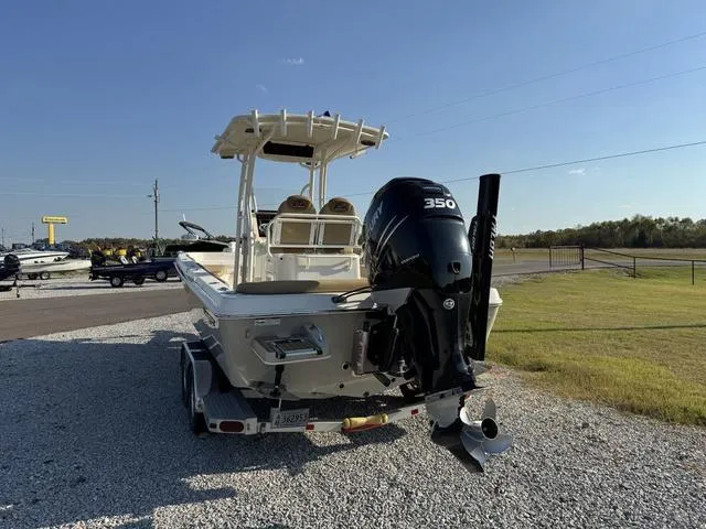 Slide: The Image of 2018 Ranger 2350 Bay boat with powerful 350 engine on trailer, parked outdoors. - 5