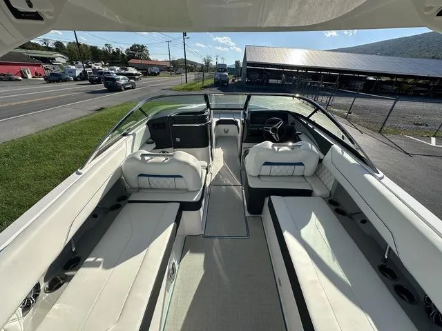 Slide: The Image of 2023 Regal LS6 boat interior with white seating and modern dashboard. - 10