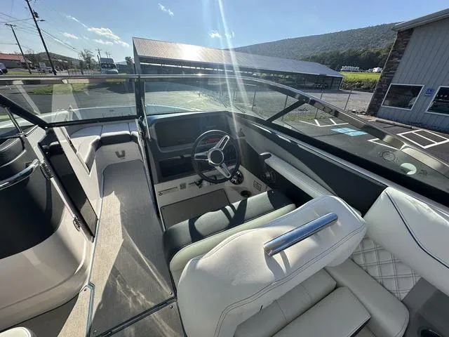 Slide: The Image of Interior view of 2023 Regal LS6 boat with steering wheel and seating. - 12