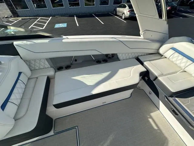 Slide: The Image of 2023 Regal LS6 boat interior with white leather seating and modern design. - 13