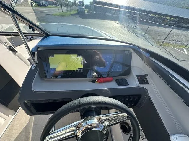Slide: The Image of 2023 Regal LS6 boat dashboard with navigation screens and steering wheel. - 15