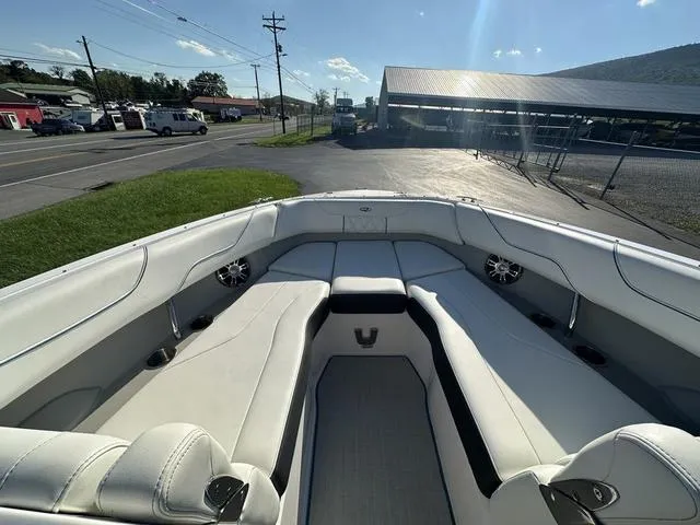 Slide: The Image of 2023 Regal LS6 boat interior with white seating and cup holders. - 18