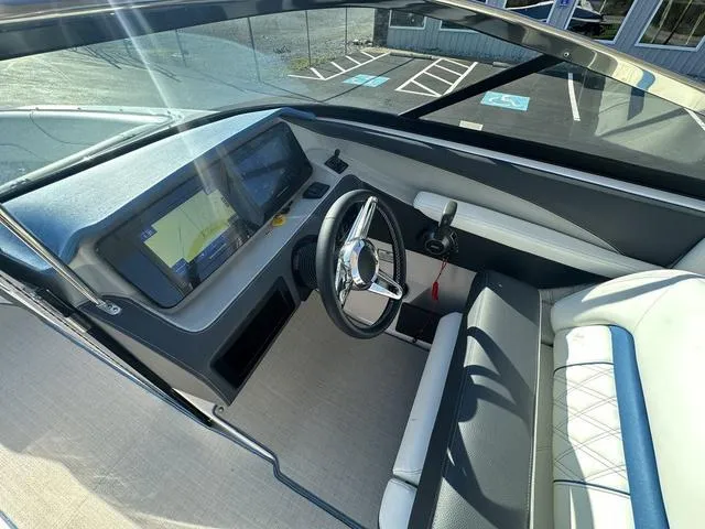 Slide: The Image of 2023 Regal LS6 boat cockpit with modern steering and navigation display. - 19