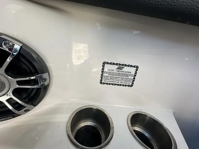 Slide: The Image of 2023 Regal LS6 yacht interior with speaker, cup holders, and certification label. - 21