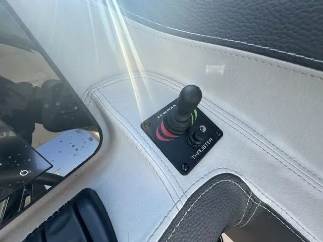 Slide: The Image of 2023 Regal LS6 boat thruster control panel with joystick in cockpit. - 22