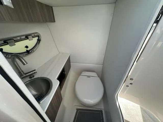 Slide: The Image of 2023 Regal LS6 boat bathroom with sink, toilet, and modern fixtures. - 23