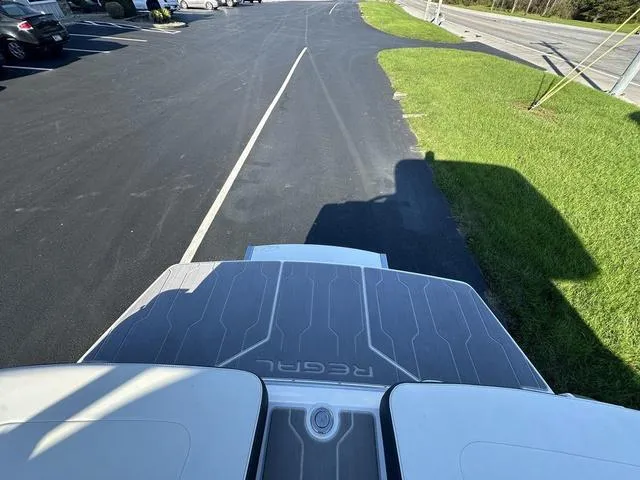 Slide: The Image of 2023 Regal LS6 boat on a paved road, shadow cast on grass. - 8