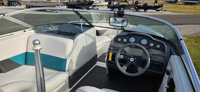 Slide: The Image of Interior of a 1993 MasterCraft Maristar 225 boat with steering wheel and seating. - 10