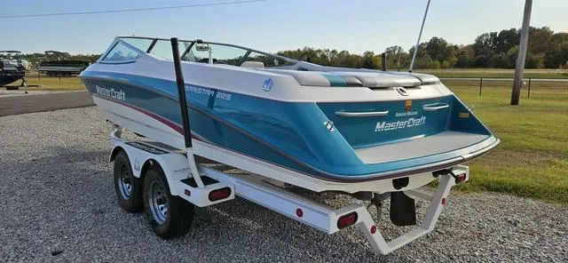 Slide: The Image of 1993 MasterCraft Maristar 225 boat on trailer, parked on gravel. - 4