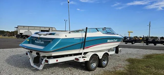 Slide: The Image of 1993 MasterCraft Maristar 225 boat on trailer in parking lot. - 6