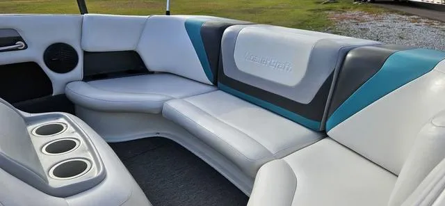 Slide: The Image of 1993 MasterCraft Maristar 225 boat interior with white and teal seating. - 9