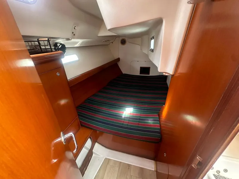 Slide: The Image of Cozy cabin interior of 2006 Beneteau 393 sailboat with striped bedding. - 21
