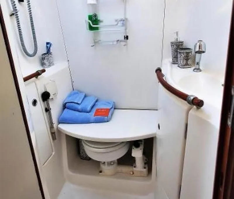 Slide: The Image of Beneteau 393 2006 yacht bathroom with toilet, sink, and towels. - 25