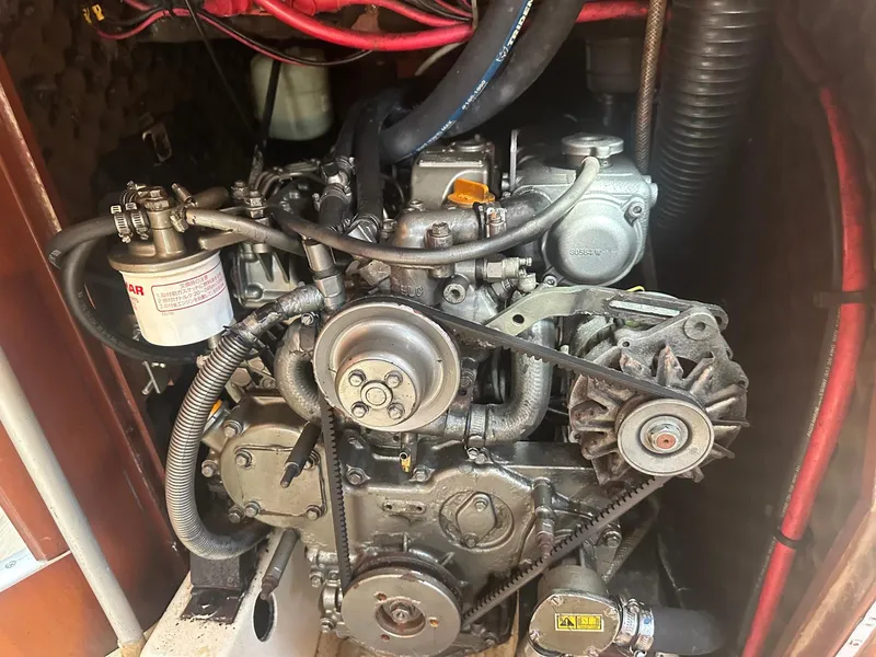 Slide: The Image of Engine compartment of a 2006 Beneteau 393 sailboat, showcasing mechanical components and wiring. - 28
