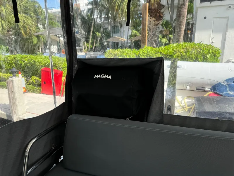 Slide: The Image of Interior of 2020 Fountaine Pajot Elba 45 with Magma grill, lush greenery outside. - 12