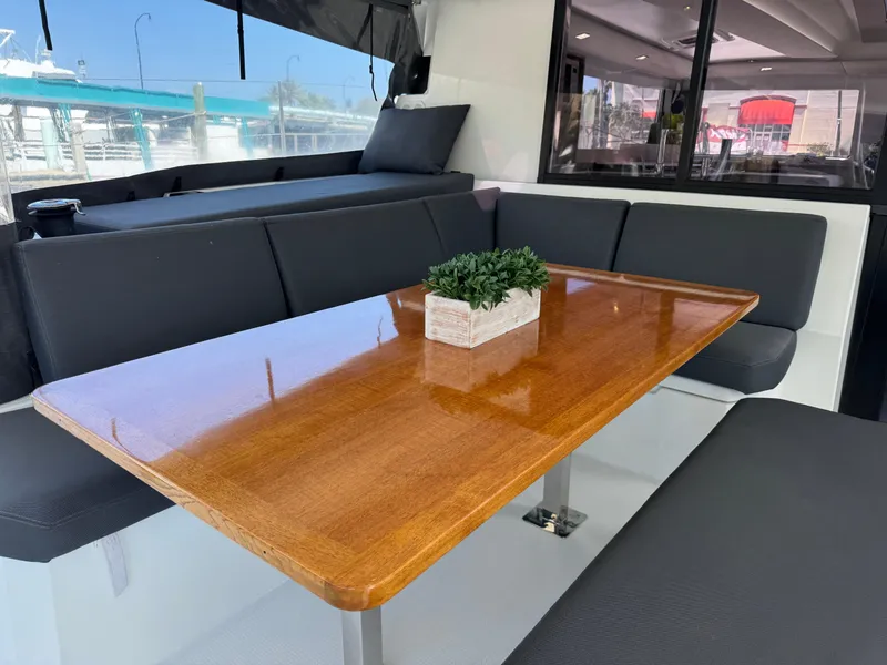 Slide: The Image of Interior of 2020 Fountaine Pajot Elba 45 yacht with sleek dining area and wooden table. - 18