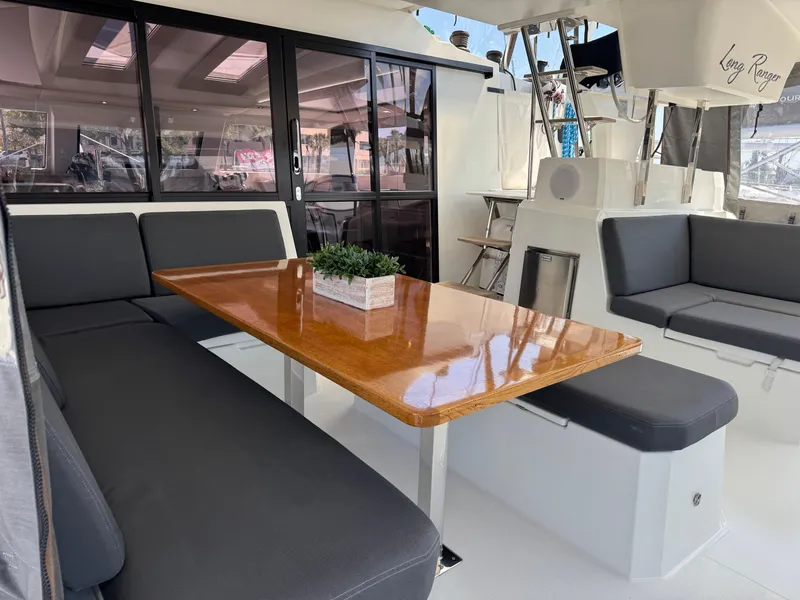 Slide: The Image of Interior of 2020 Fountaine Pajot Elba 45 catamaran with sleek seating and wooden table. - 19
