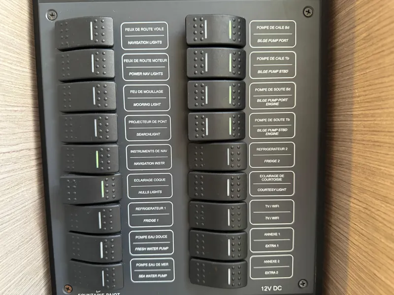 Slide: The Image of Control panel of a 2020 Fountaine Pajot Elba 45 catamaran with labeled switches. - 23