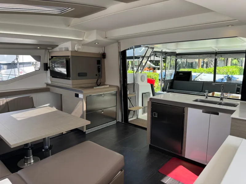Slide: The Image of Modern interior of 2020 Fountaine Pajot Elba 45 catamaran with kitchen and seating area. - 31