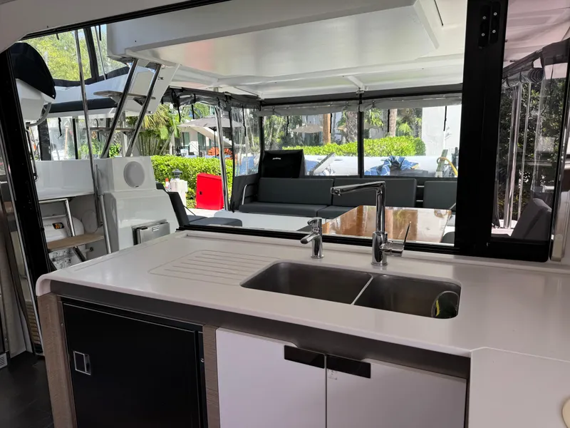 Slide: The Image of Interior of 2020 Fountaine Pajot Elba 45 catamaran with modern kitchen and seating area. - 34