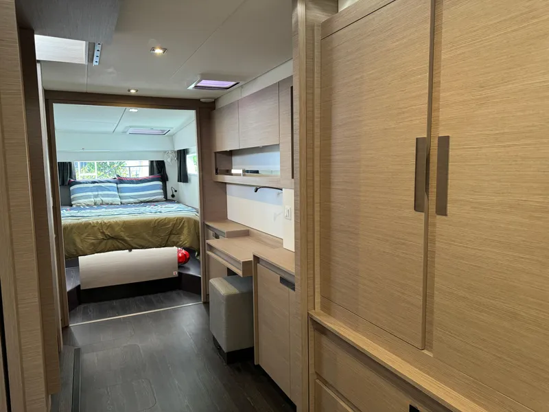 Slide: The Image of Interior of 2020 Fountaine Pajot Elba 45 catamaran, featuring a cozy bedroom and modern wood finishes. - 43