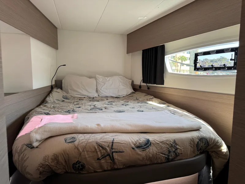 Slide: The Image of Cozy bedroom in 2020 Fountaine Pajot Elba 45 catamaran with nautical-themed bedding. - 45