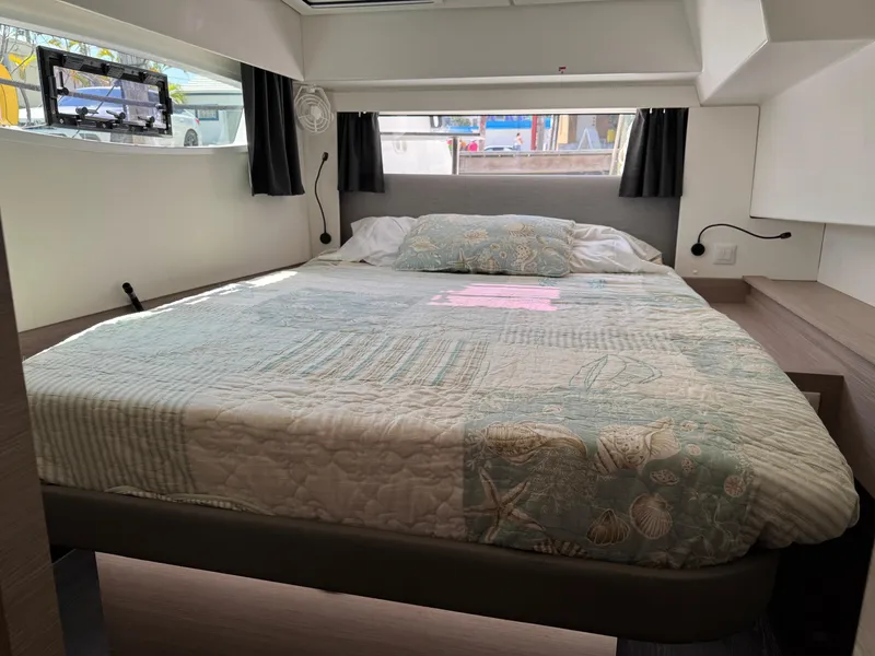 Slide: The Image of Cozy bedroom interior of 2020 Fountaine Pajot Elba 45 catamaran with nautical-themed bedding. - 47