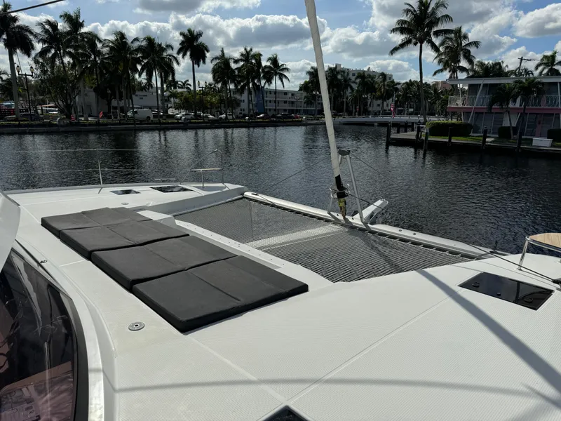 Slide: The Image of 2020 Fountaine Pajot Elba 45 catamaran docked by palm-lined waterfront. - 54