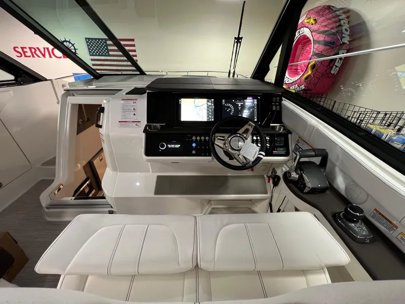 Slide: The Image of 2025 Sea Ray Sundancer 320 Coupe cockpit with modern controls and sleek design. - 10