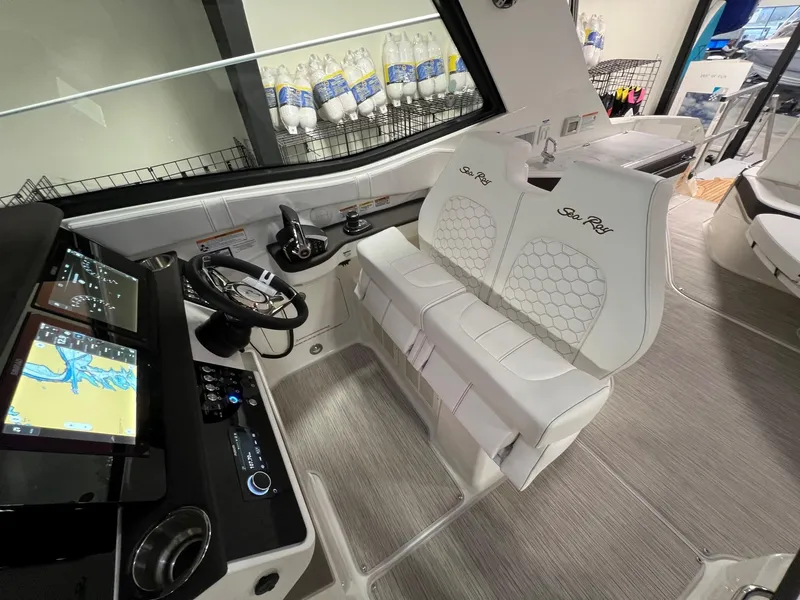 Slide: The Image of 2025 Sea Ray Sundancer 320 Coupe cockpit with modern navigation system and plush seating. - 11