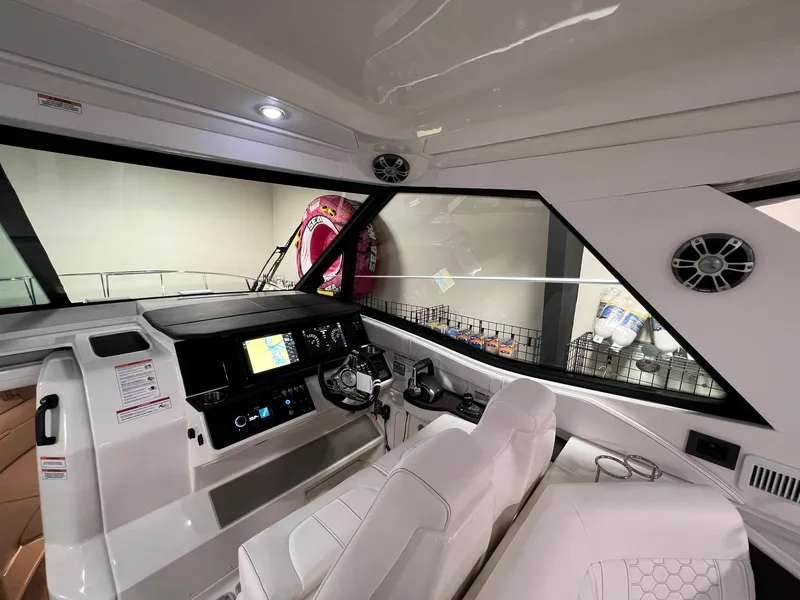 Slide: The Image of 2025 Sea Ray Sundancer 320 Coupe cockpit with modern controls and sleek design. - 12