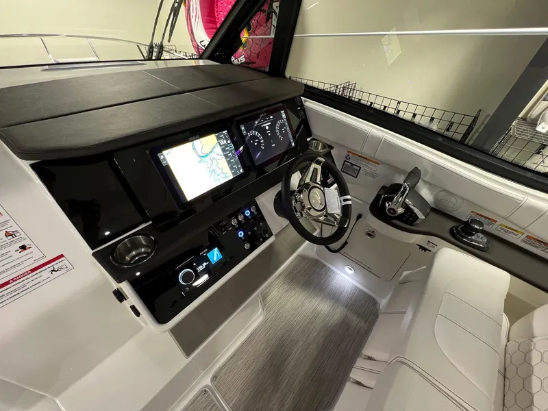 Slide: The Image of 2025 Sea Ray Sundancer 320 Coupe helm with modern navigation and control systems. - 16