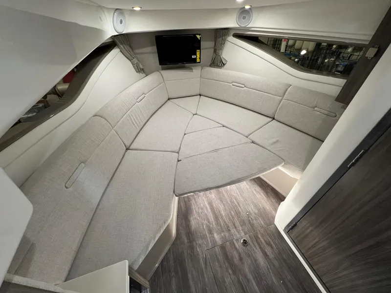 Slide: The Image of 2025 Sea Ray Sundancer 320 Coupe interior with plush seating and modern design. - 17