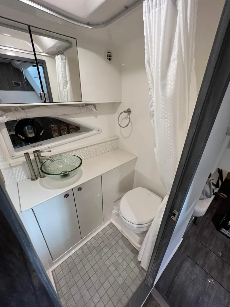 Slide: The Image of 2025 Sea Ray Sundancer 320 Coupe bathroom with modern fixtures and sleek design. - 18