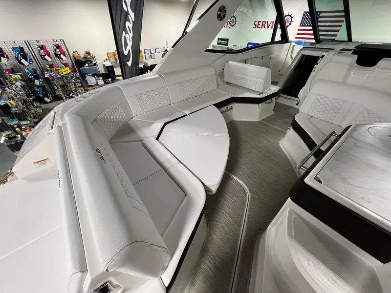 Slide: The Image of 2025 Sea Ray Sundancer 320 Coupe interior with luxurious white seating and modern design. - 3