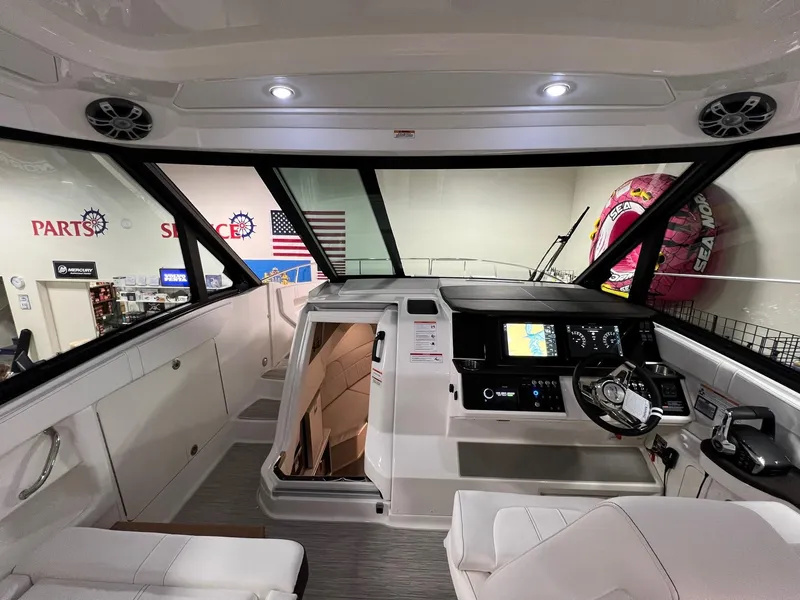 Slide: The Image of 2025 Sea Ray Sundancer 320 Coupe helm with modern controls and spacious interior. - 9