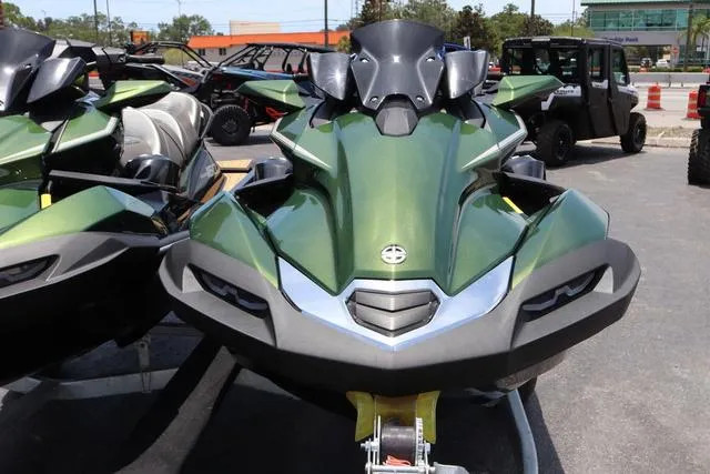 Slide: The Image of 2025 Kawasaki Jet Ski Ultra 310 in green, parked outdoors. - 6
