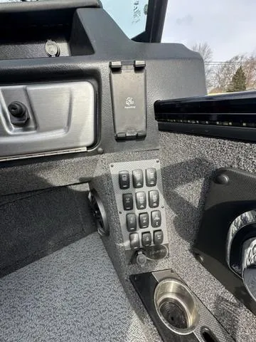 Slide: The Image of Lowrance fishfinder and gauges on 2024 Lund 2175 Pro-V Sport boat dashboard. - 13